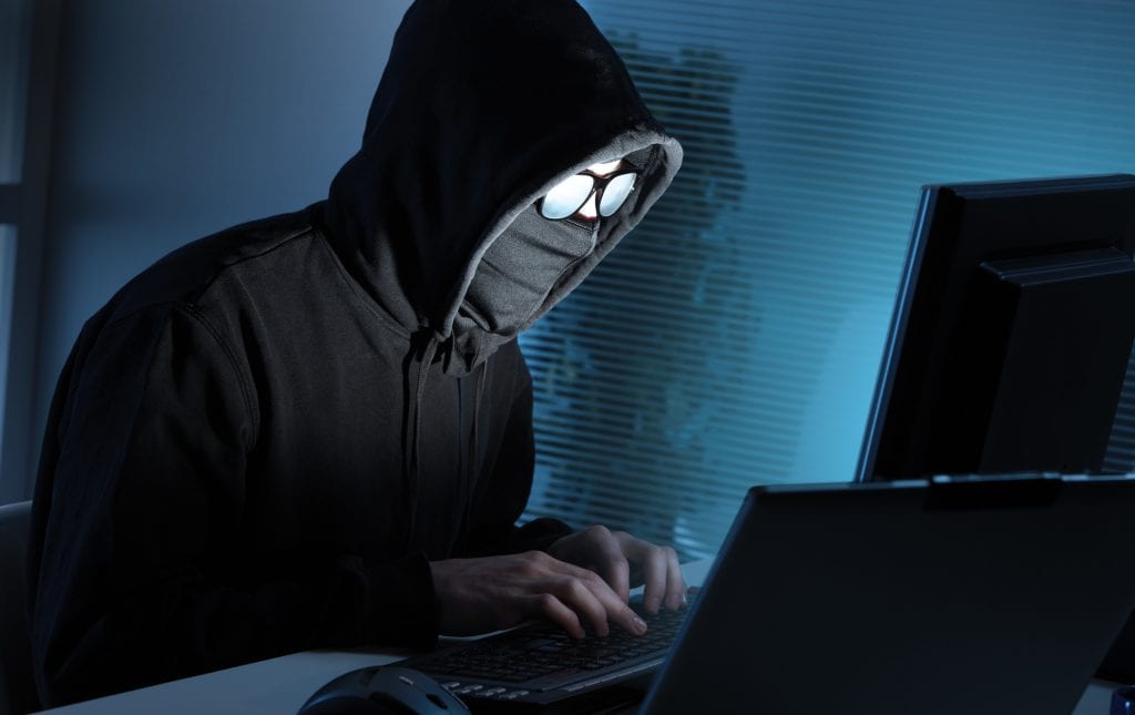 hacker in black hood