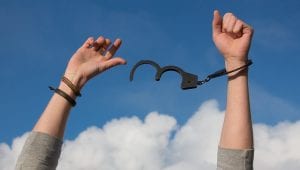 hands with handcuffs that are open