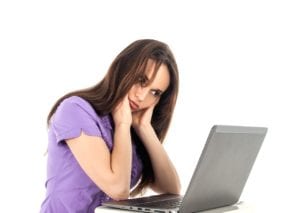 girl in front of a computer looking anxious
