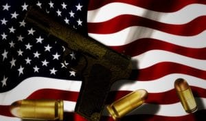 gun and bullets against american flag backdrop