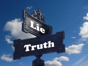 Street signs, one saying truth and one saying lie